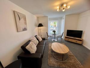 剑桥Lime Tree in blue Duplex Serviced Apartment的客厅配有沙发和桌子