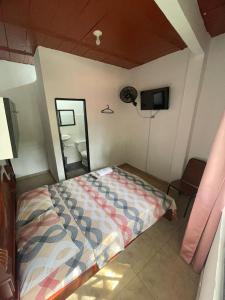 JamundíHostal MONARCA的一间卧室配有一张床和镜子