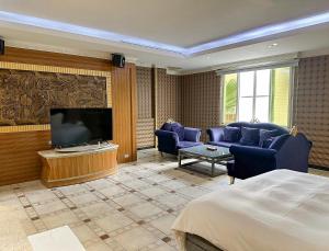 竹山欧游国际连锁精品旅馆的配有一张床和一台平面电视的酒店客房