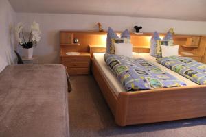 瓦门施泰纳赫Ferienwohnung Werner的一间卧室配有两张带蓝色枕头的床