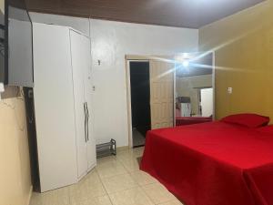 马卡帕Loft privativo .的一间卧室配有红色的床和镜子