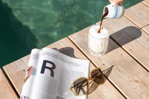 格罗萨尔奈斯勒霍夫酒店的阅读报纸的人,喝上一杯,戴太阳镜