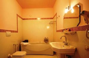 诺切拉泰里内塞乌纳努欧瓦斯特拉达皇宫酒店的带浴缸、卫生间和盥洗盆的浴室
