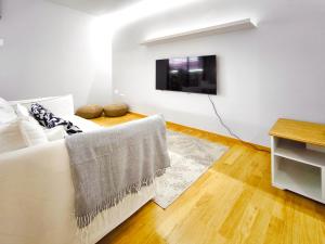 特拉萨Moderno apartamento tipo loft en Terrassa centro的客厅配有白色沙发和电视