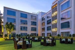 卡兰古特Hyatt Centric Candolim Goa的大楼前设有桌椅的酒店