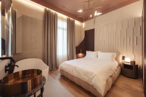 塞萨洛尼基Zenith Premium Suites的一间卧室配有一张床和浴缸