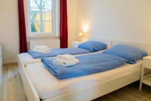 拉本基尔兴-福吕克Schleiblick App 10的客房内的两张床和毛巾