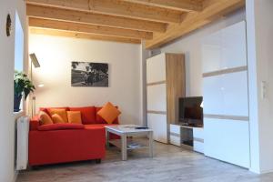 乌姆基希Kleines Ferienhaus in Umkirch - b57430的客厅配有红色沙发和电视