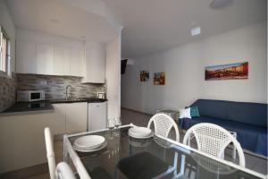 圣米格尔德阿沃纳GOLF PARK Resort的厨房以及带桌椅的起居室。