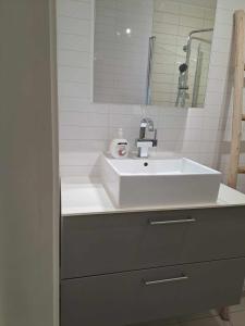 克里斯蒂安桑Apartment Bystranda - City Beach的浴室设有白色水槽和镜子