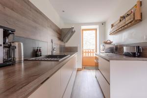 Saint-MarcelChalet Mariejo, Sauna et Charme Alpin的厨房配有白色橱柜和台面