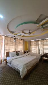 锡卡都Baltistan Continental的一间卧室设有两张床和天花板