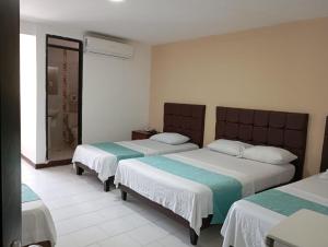 巴兰基亚巴兰基亚宾馆的一间卧室设有两张床和淋浴。
