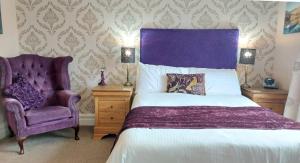 温德米尔Invergarry Room Only Guest House For Adults的一间卧室配有一张紫色的床和一把椅子