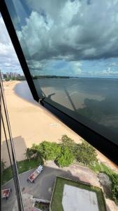 马瑙斯Flat no Condomínio do Edifício Tropical Executive e residence com Vista para o Rio的飞机享有海滩和大海的景致。