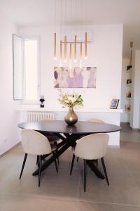 巴里Via Dante Luxury Home的一间用餐室,配有一张黑桌子和两把椅子