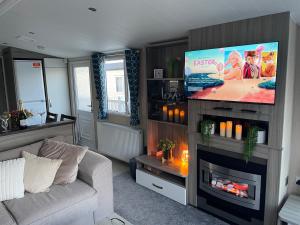 纽顿Luxury Romantic 2 Bedroom Caravan Trecco Bay的带沙发和平面电视的客厅