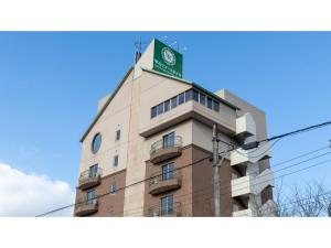 雫石町SHIZUKUISHI RESORT HOTEL - Vacation STAY 29557v的上面有绿色旗帜的建筑