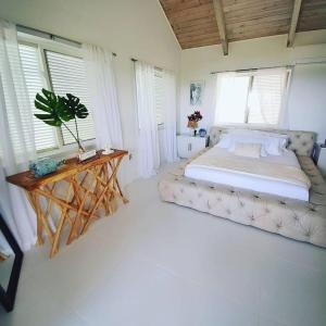Tulixx Cayman Villa的一间卧室配有一张大床和一张桌子