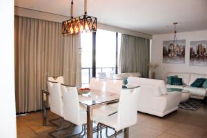 圣萨尔瓦多The Luxury Apartment的用餐室以及带桌椅的起居室。