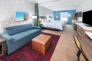韦瑟福德Home2 Suites By Hilton Weatherford的酒店客房设有一张沙发和一张床