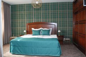 普列文Hotel Balkan的一间卧室配有一张带蓝色枕头的大床