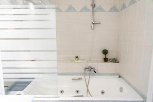 雅典四季酒店的浴室设有浴缸和淋浴。