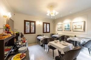 威尼斯Hotel Palazzina Sardi的一间在房间内配有桌椅的餐厅