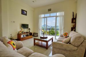 康提Amandara Hills Kandy的客厅配有两张沙发和一台电视