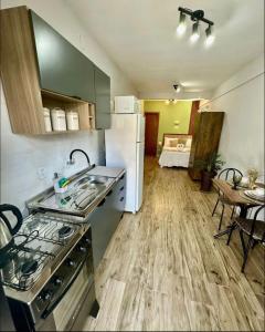 圣若泽Apartamentos - Estúdios的厨房配有炉灶、冰箱和桌子
