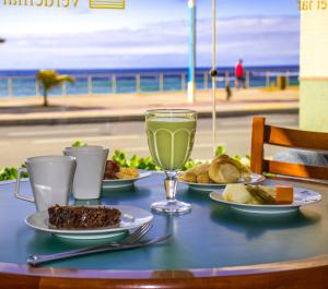 萨尔瓦多维德马尔酒店的海滩上一张桌子,上面放着盘子和饮料