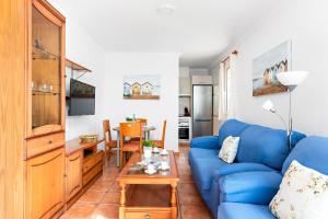 蓬塔普里马Villa Sol Menorca的客厅配有蓝色的沙发和桌子