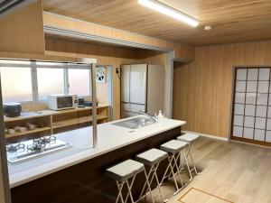 出云市Izumo no Oyado Naka Araki - Vacation STAY 82773v的厨房配有水槽和带凳子的台面