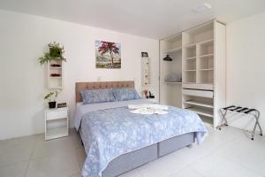 弗洛里亚诺波利斯Hospedaria Conceitual的一间白色卧室,配有一张床和一个衣柜