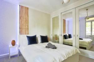 悉尼Ideal 3 Bedroom House in Chippendale with 2 E-Bikes Included的卧室配有一张带镜子的白色大床