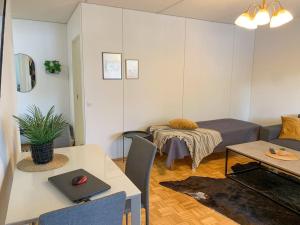 奥卢Tilava 2BR-huoneisto Saunalla的客厅配有沙发和带笔记本电脑的桌子