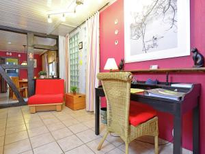 巴特皮尔蒙特博索公寓的办公室,配有书桌和红色椅子