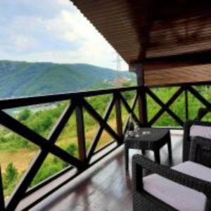 杜博瓦乡Pensiunea Decebal Resort - Cazanele Dunarii的山景阳台(带桌子)