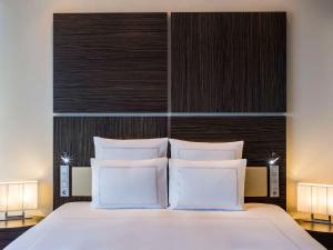塔林塔林瑞士酒店的卧室配有带白色枕头的大床