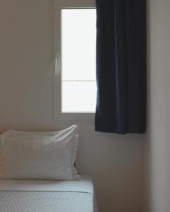 阿尔布费拉维加斯公寓的一间卧室设有窗户和一张带枕头的床