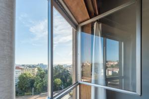 波尔图GuestReady - Woodwork Apartment的享有城市美景的开放式窗户。