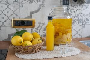维克艾库塞庭院之家住宿加早餐旅馆的一碗柠檬和一瓶橙汁以及一篮水果