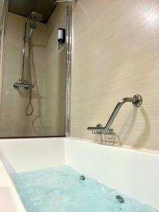 格拉纳达Hotel Tent Granada的浴缸、蓝色淋浴和