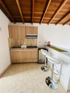 麦德林El Noral的厨房配有柜台和2把凳子