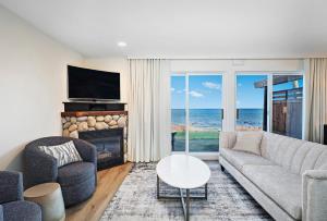 考特尼Kingfisher Pacific Resort & Spa的带沙发和壁炉的客厅以及海洋