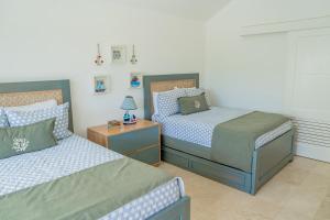 圣斐利-银港Xeliter Green One Playa Dorada的一间卧室设有两张单人床和一个床头柜。