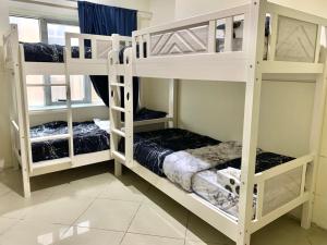 迪拜Ramble stay Hostel Bur Dubai的客房内的2张白色双层床
