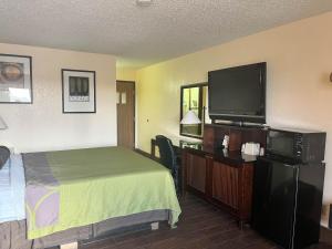 德明Motel 6 Deming, NM的配有一张床和一台平面电视的酒店客房