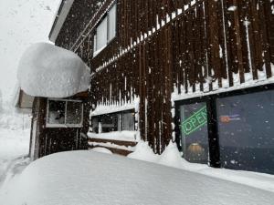 Anaba Lodge的建筑物一侧的一堆积雪