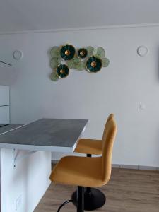 哥西尔Studio de charme au Gosier的墙上一张桌子,上面有椅子和盘子